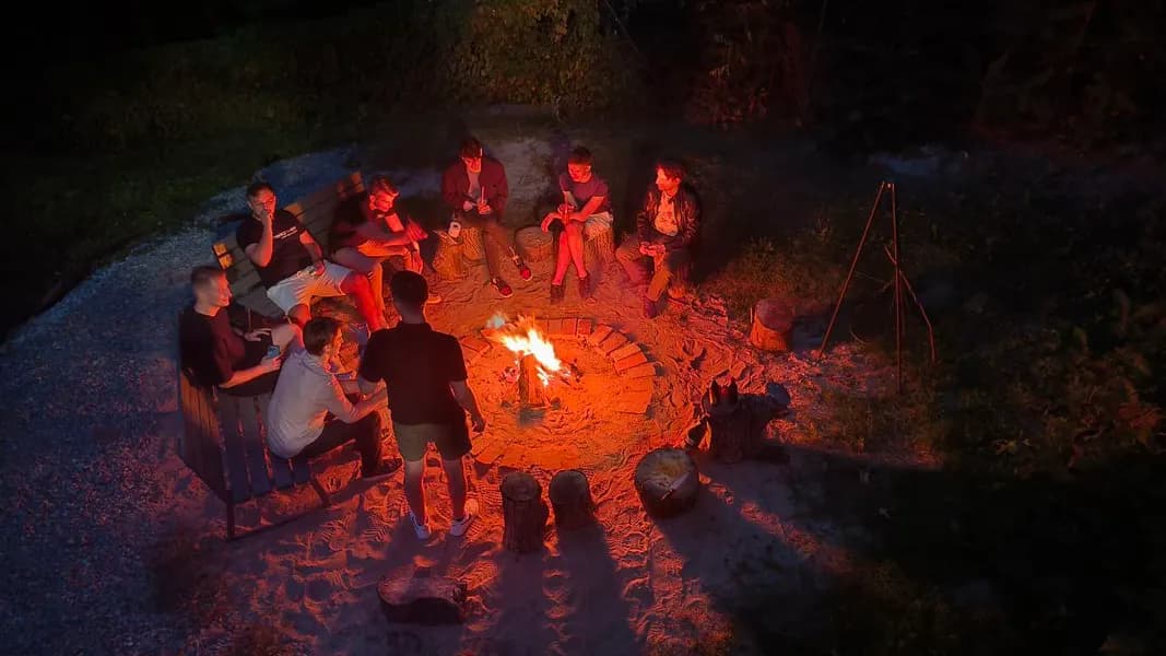 Team gathered around an evening campfire