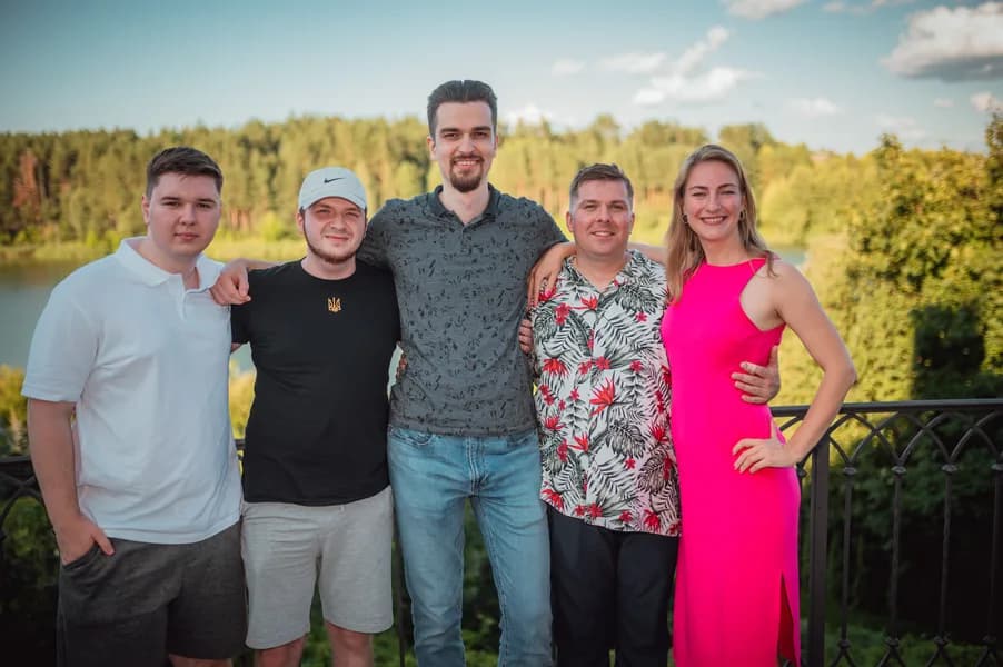 Teammates on a terrace overlooking the lake